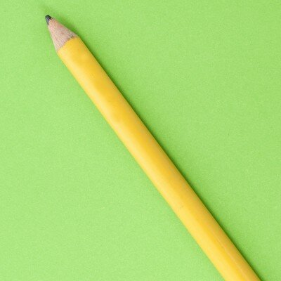 Yellow pencil on a green background